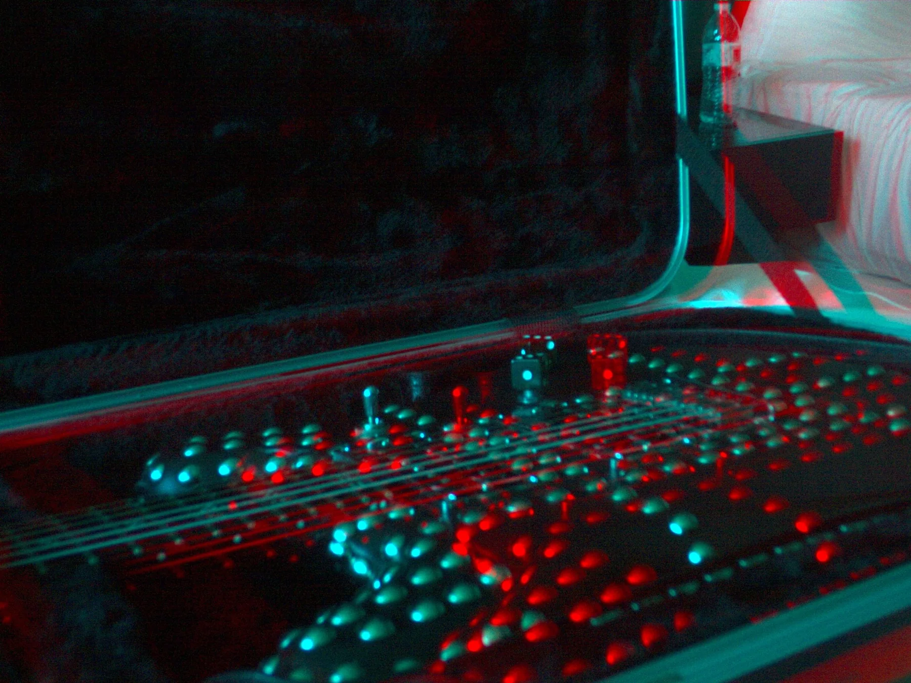 Wide red and cyan 3D photograph of Andrew Dice Clay’s guitar inside its case
