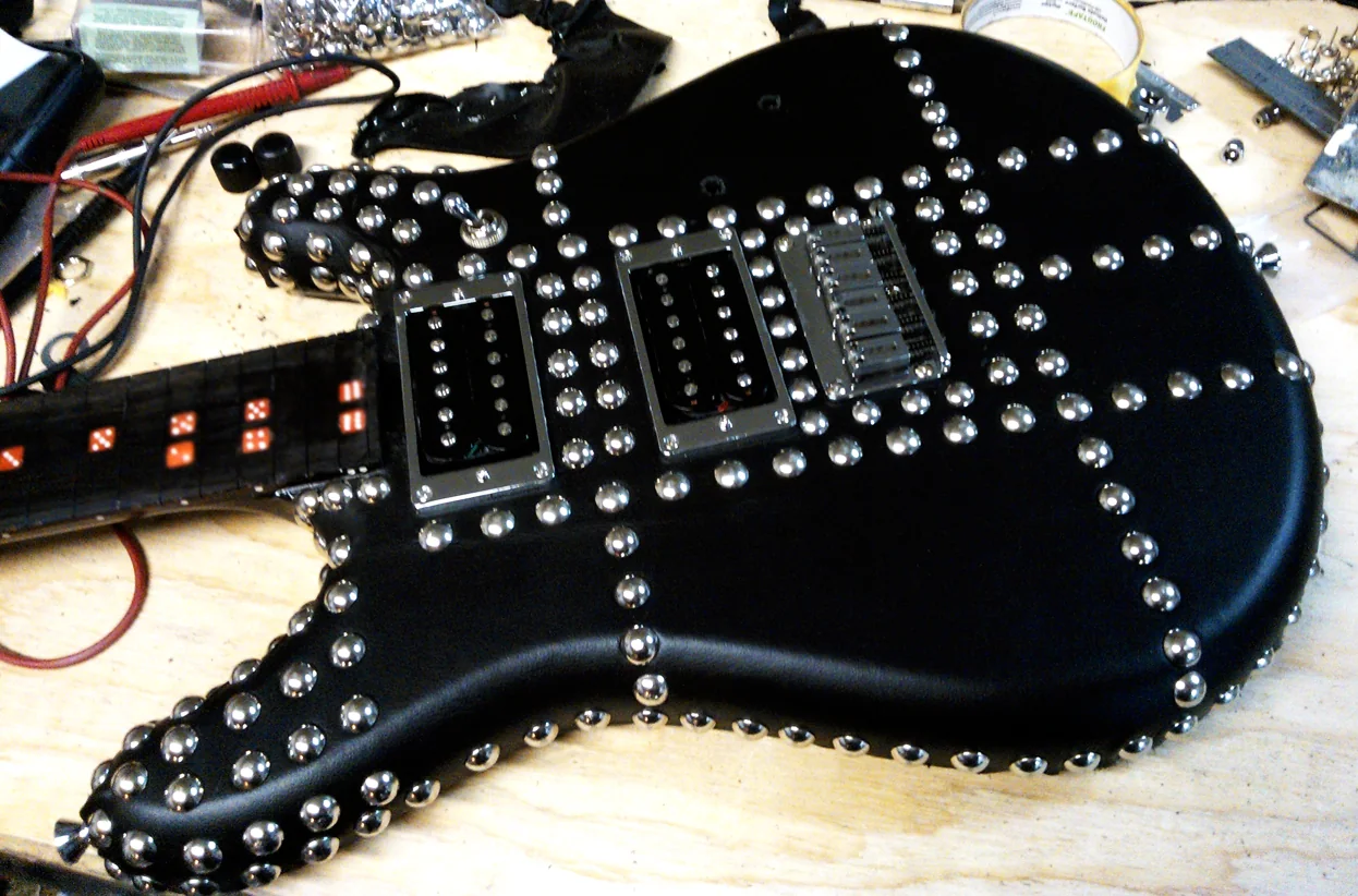 Close view of the leather wrapped Andrew Dice Clay guitar during construction
