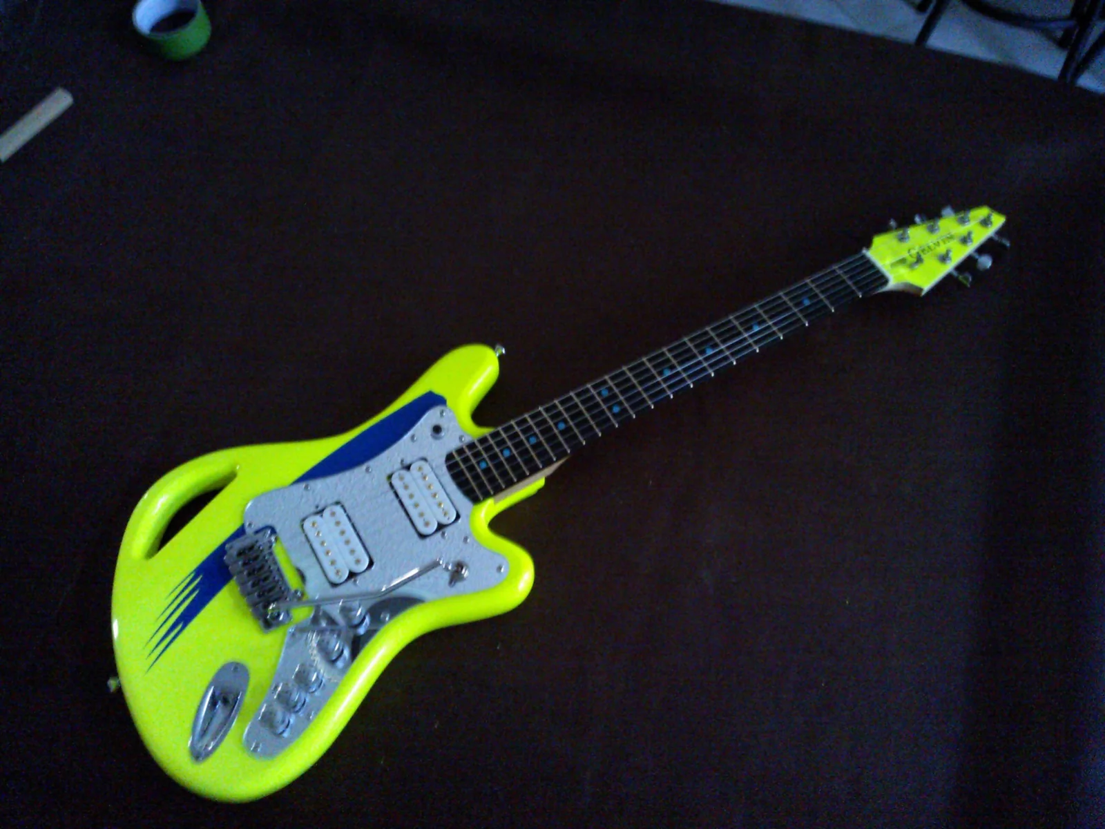 Finished Dale Bozzio SSM guitar at an angle on a black background
