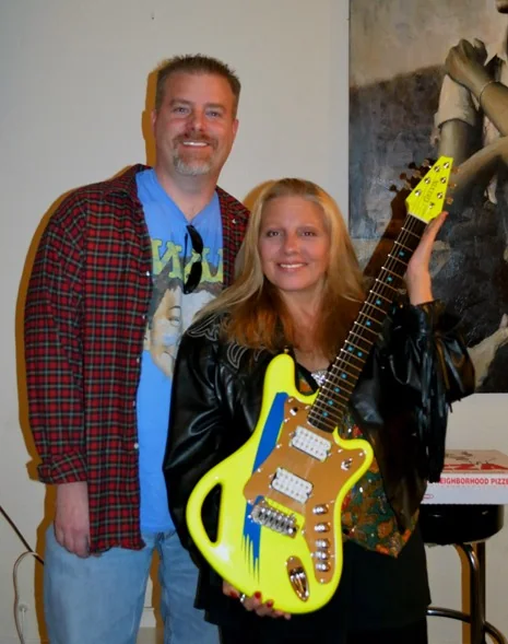 Will Gelvin and Dale Bozzio holding her custom neon Gelvin SSM guitar