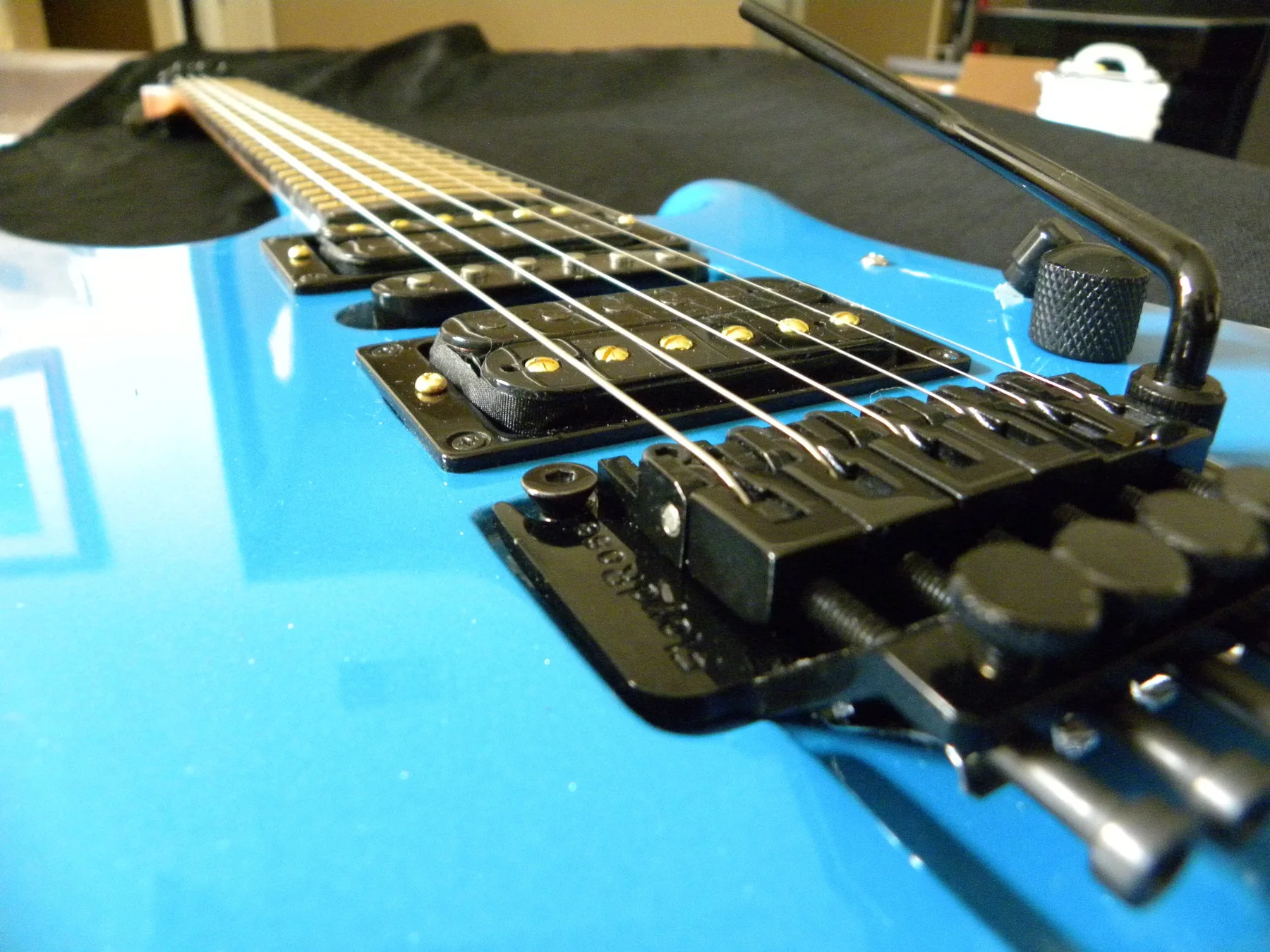 Close view of the baby blue Gelvin OGS bridge, pickups and controls