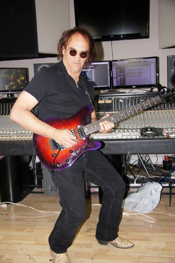 Jamie Glaser playing the red and purple Gelvin JG guitar in the studio