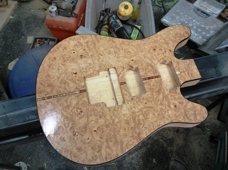 Burl veneer body showing the center stripe carried into the JG 2.0