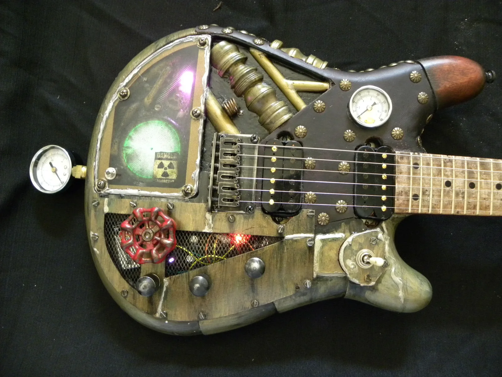 Straight-on close view of the steampunk guitar controls and pickups